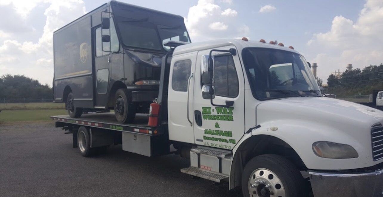 Delivery truck on flatbed rollback